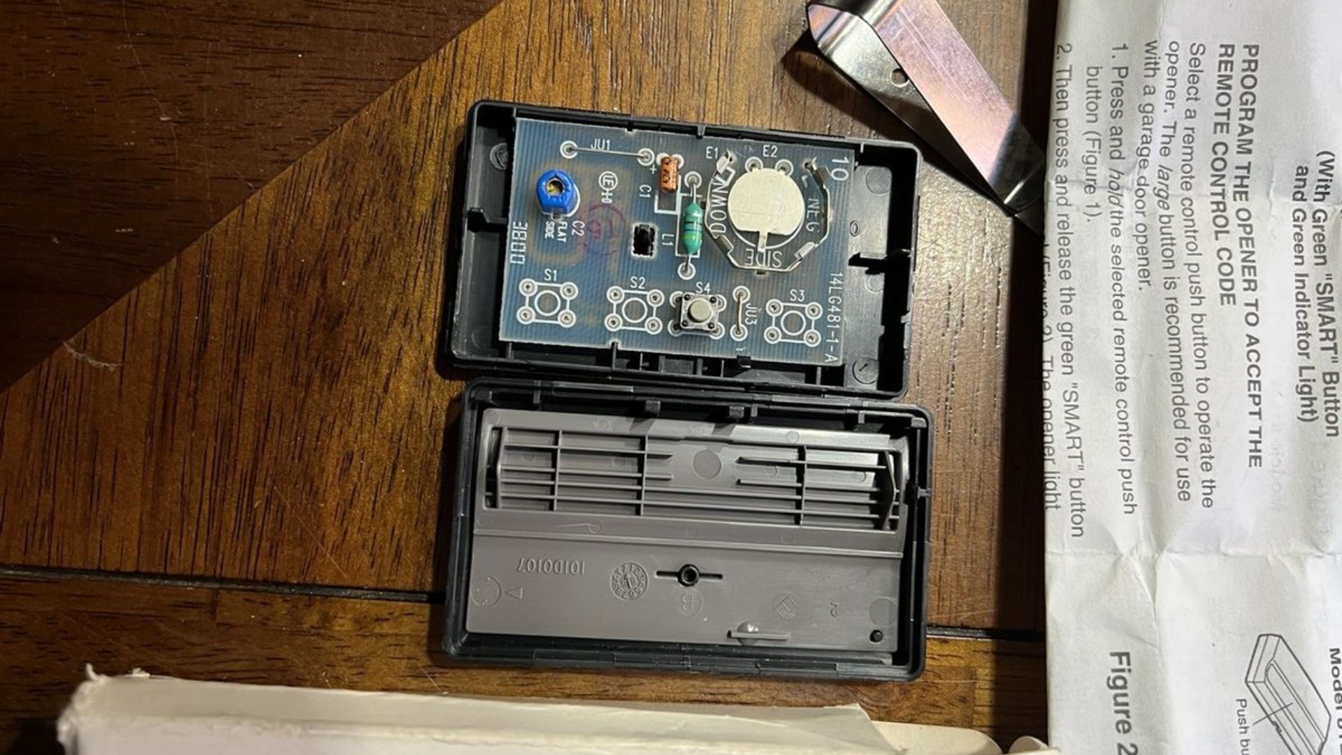 A garage door remote opened to check the wirings and battery