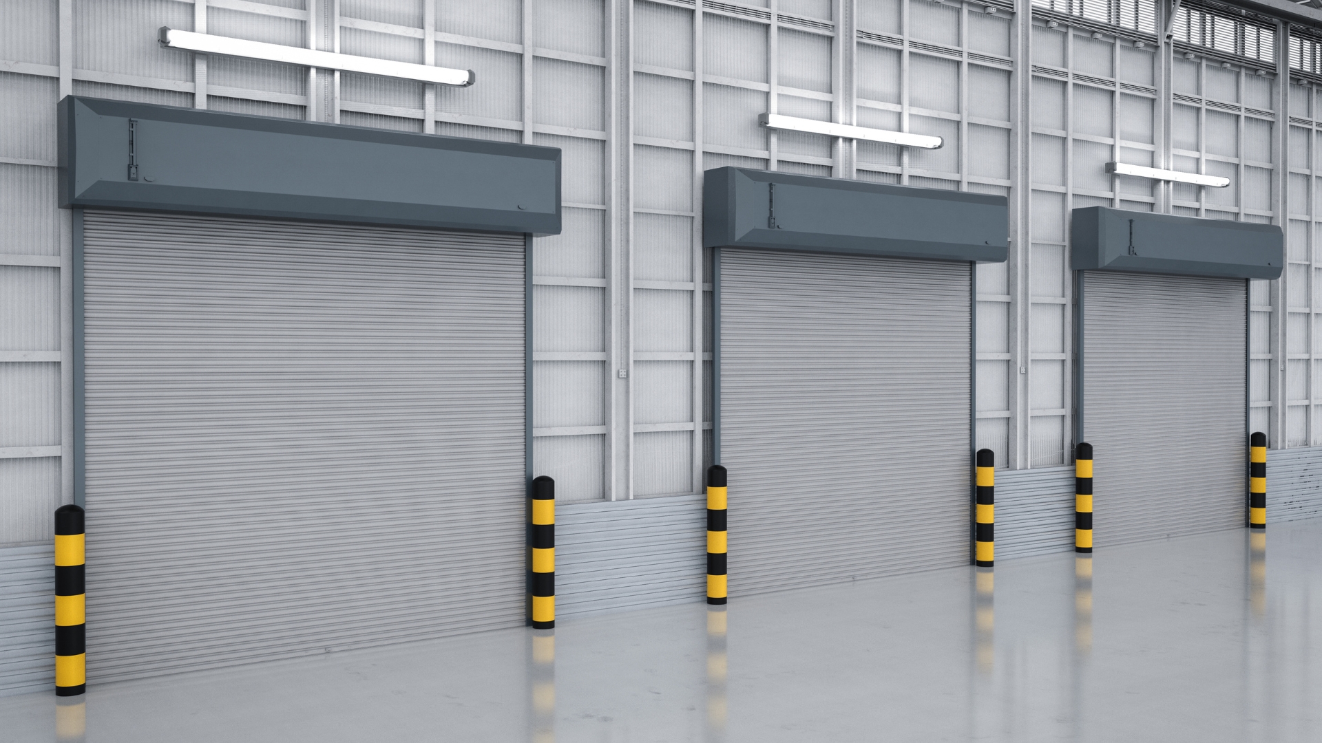 Three commercial roll-up doors in a warehouse