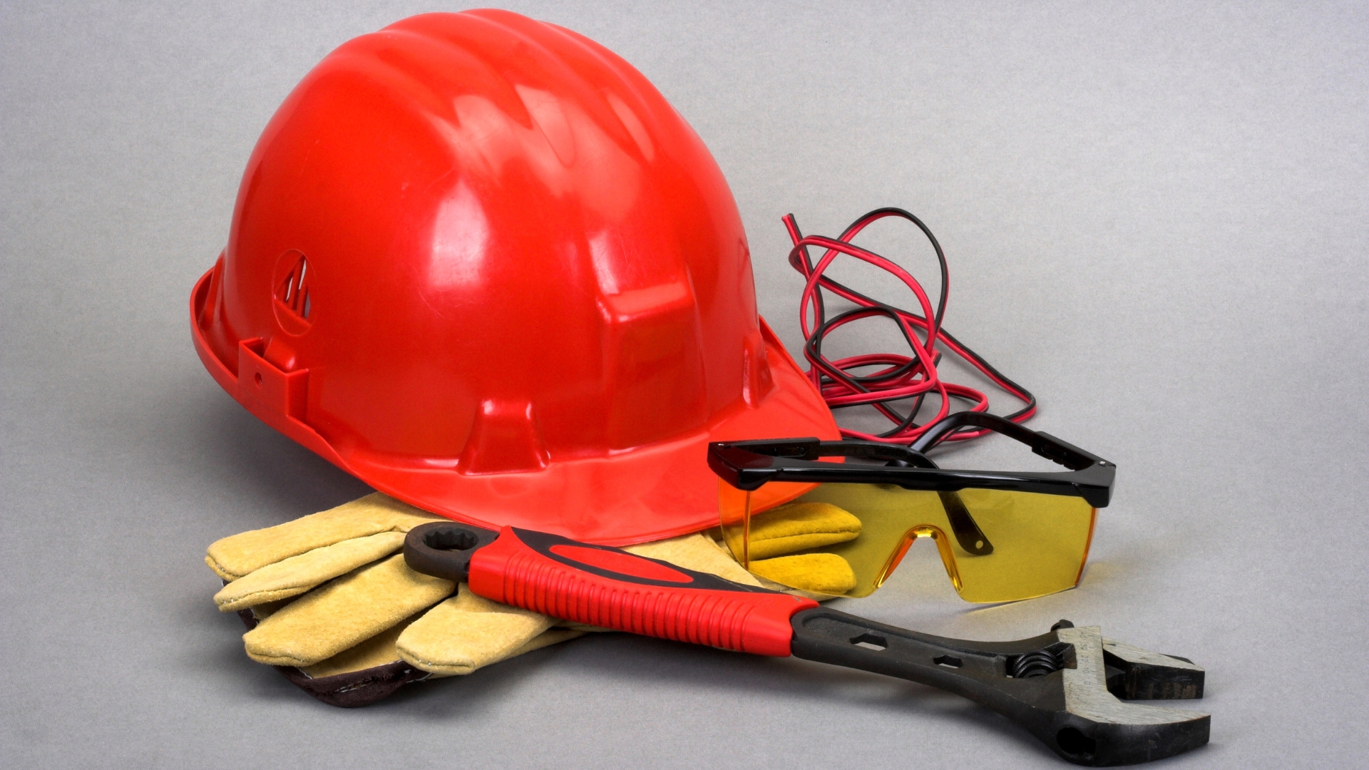 Safety gears including helmet, gloves and goggles along with a wrench