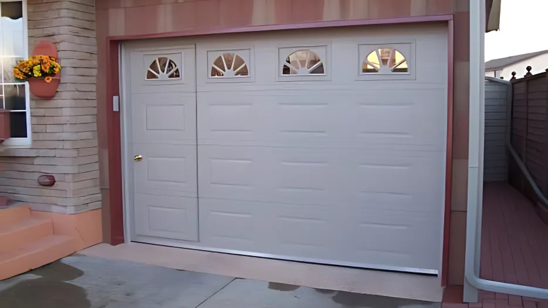 A residential garage door with a man door for easy access