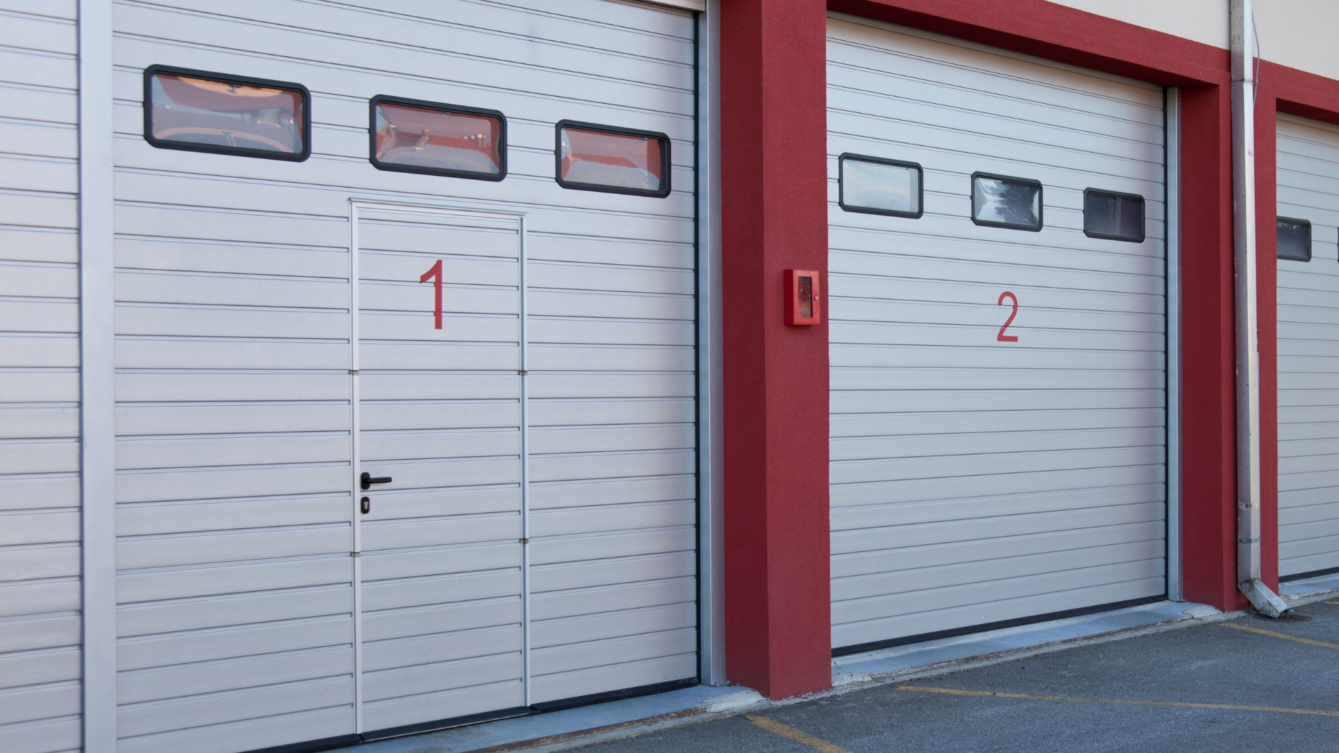 A warehouse garage door featuring a man door for easy walk-through