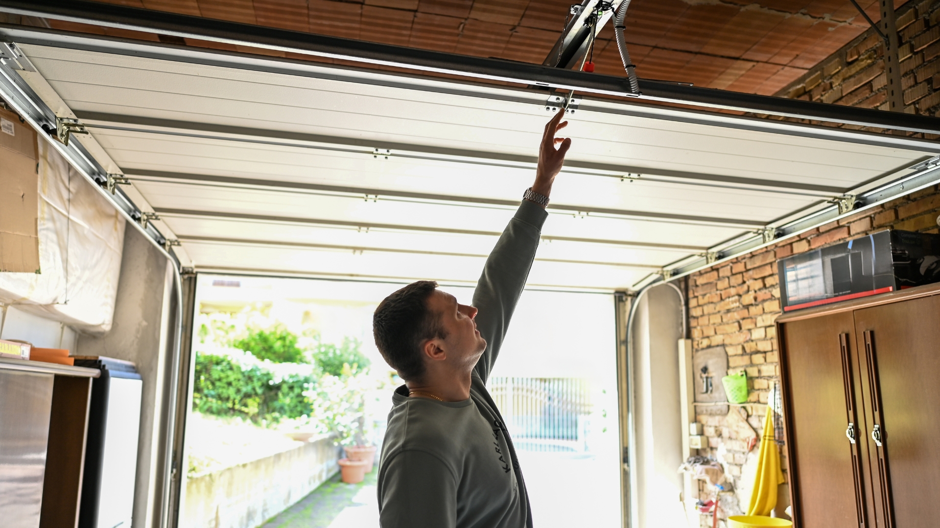 Checking the garage door mechanism for squeaky sounds.